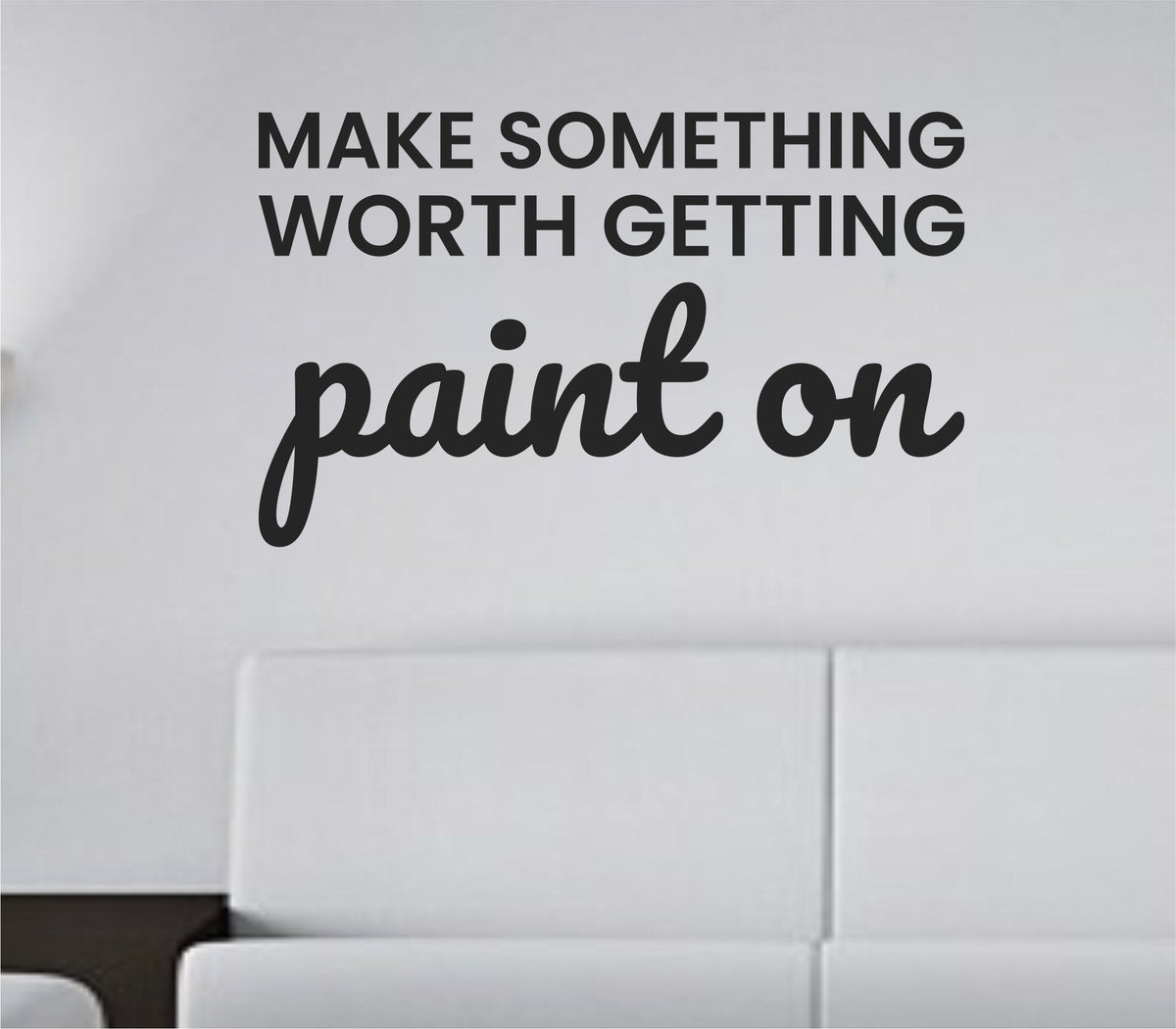 Black vinyl wall decal with the quote 'Make something worth getting paint on' in bold, simple font on a white background.
