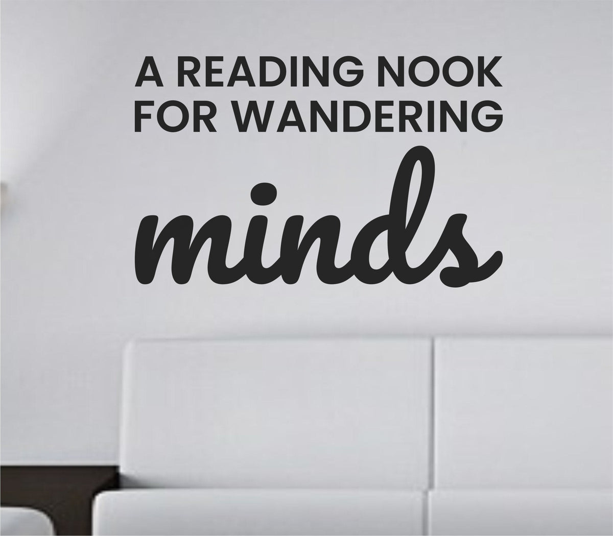 Black vinyl wall decal with the quote 'A reading nook for wandering minds' in a simple, elegant font on a white background.
