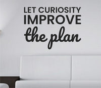 Black vinyl wall decal with the quote Let curiosity improve the plan in modern clean typography on a white background.