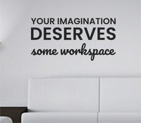 Black one-color vinyl wall decal with the phrase Your imagination deserves some workspace in a clean modern font on a white background