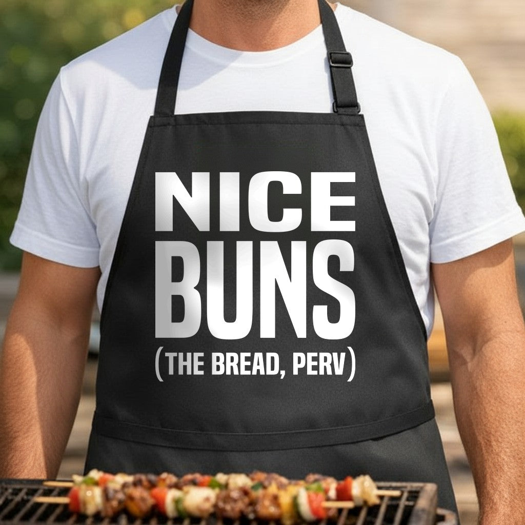 Black BBQ apron with large white text saying Nice Buns the Bread Perv in bold block letters, humorous kitchen apparel.