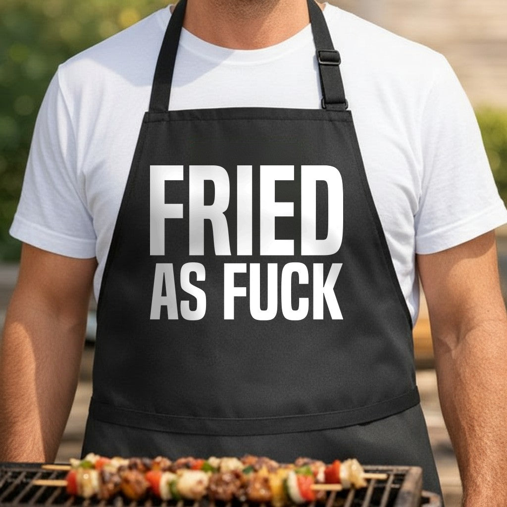 Black apron with bold white block letters spelling 'FRIED AS FUCK' in all caps on front, simple and striking design.