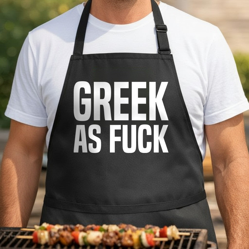 Black apron with large white bold text saying Greek As Fuck, simple and bold typography design, adult humor style