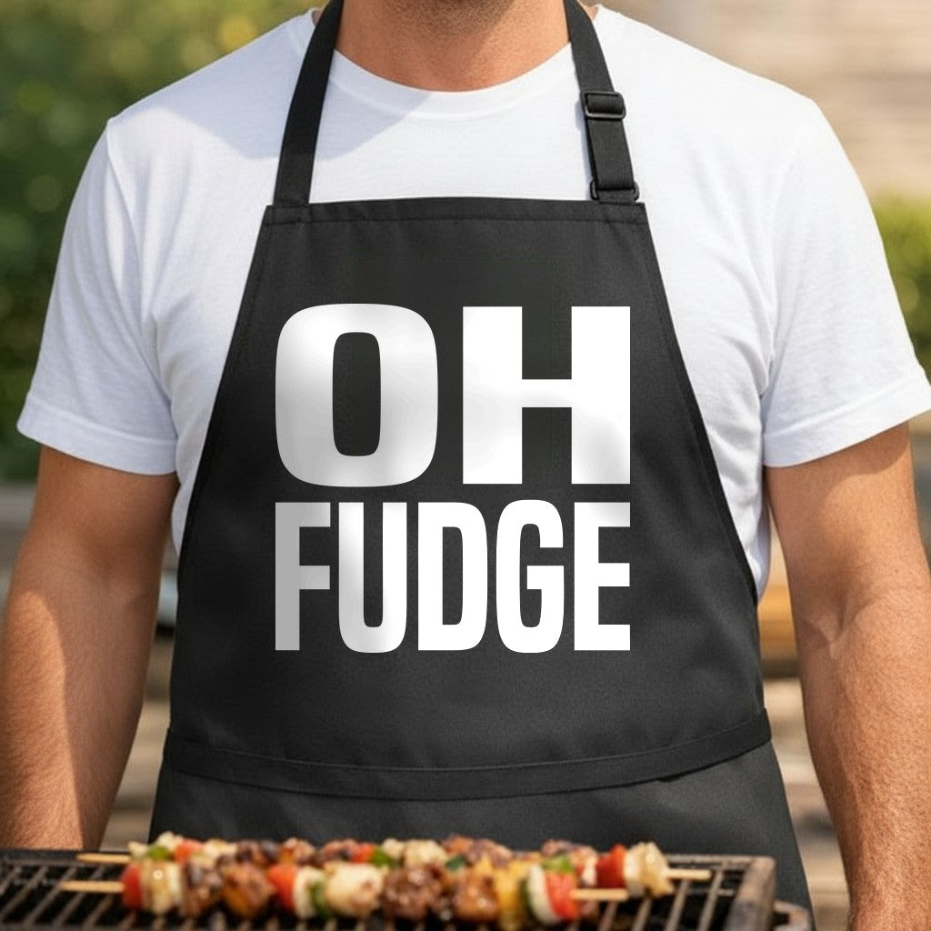 Black apron with large white bold text reading 'OH FUDGE' in block letters, simple and modern style.