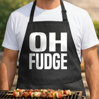 Black apron with large white bold text reading 'OH FUDGE' in block letters, simple and modern style.