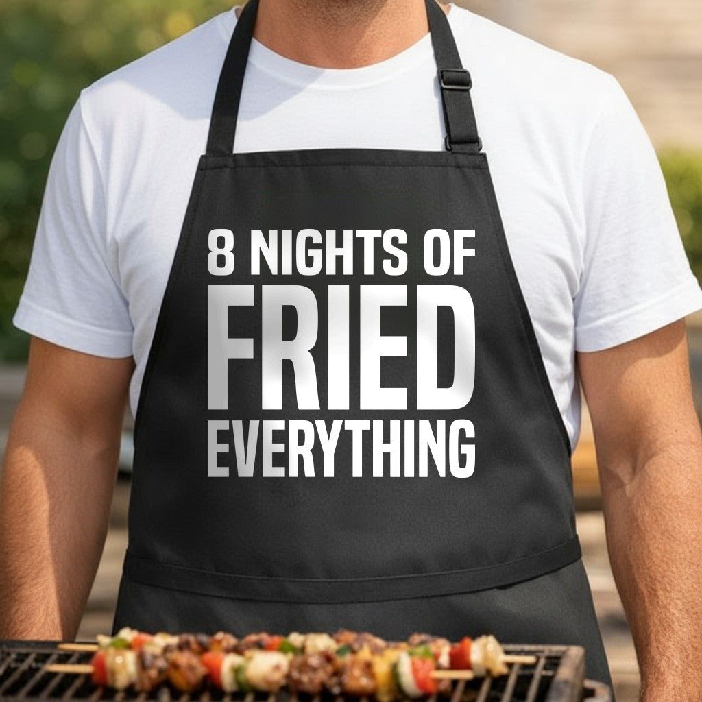 Black apron with large white text reading 8 Nights Of Fried Everything in bold block letters, humorous Hanukkah cooking theme