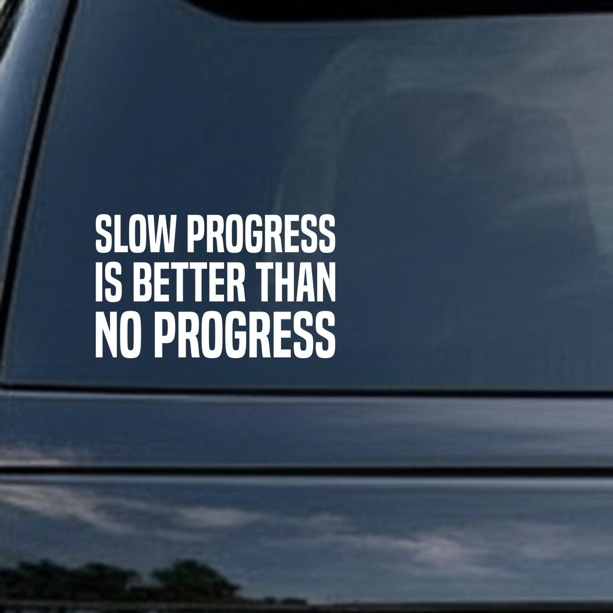 Slow Progress Is Better Than No Progress car decal in the small 6 inch size, shown in the corner of a rear window