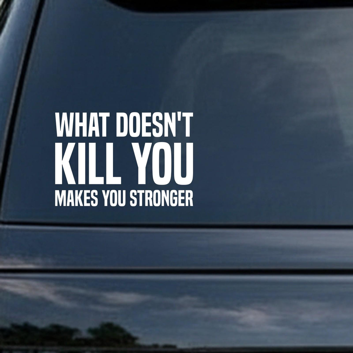 What Doesn't Kill You Makes You Stronger car decal in the small 6 inch size, shown in the corner of a rear window