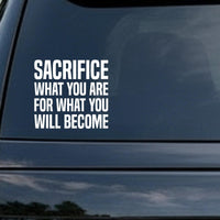 Sacrifice What You Are for What You Will Become car decal in the small 6 inch size, shown in the corner of a rear window