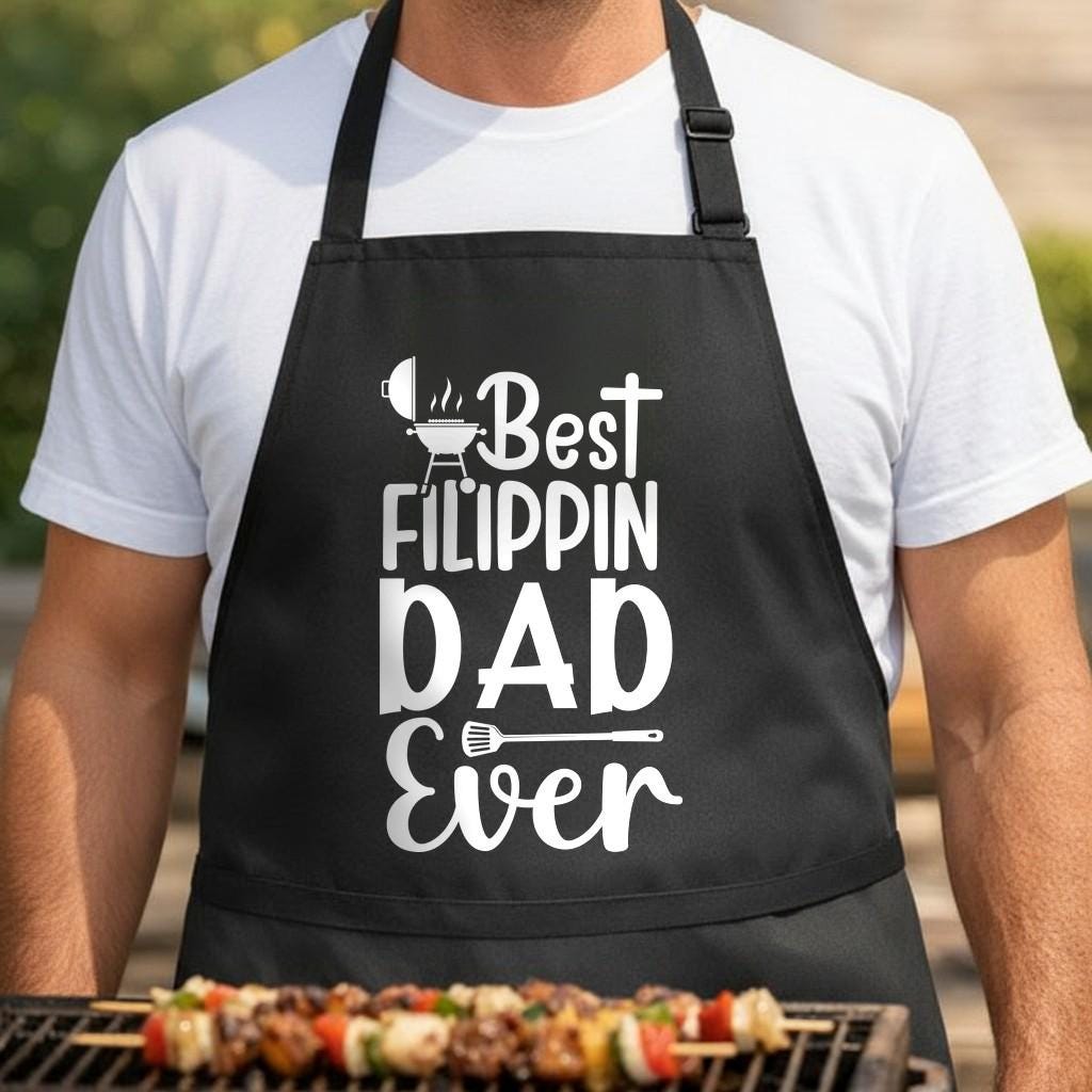 Best Flippin' Dad Ever black BBQ apron, torso close-up: Black apron with white text saying Best Flippin Dad Ever, featuring a grill, steam lines, and a spatula graphic in white.
