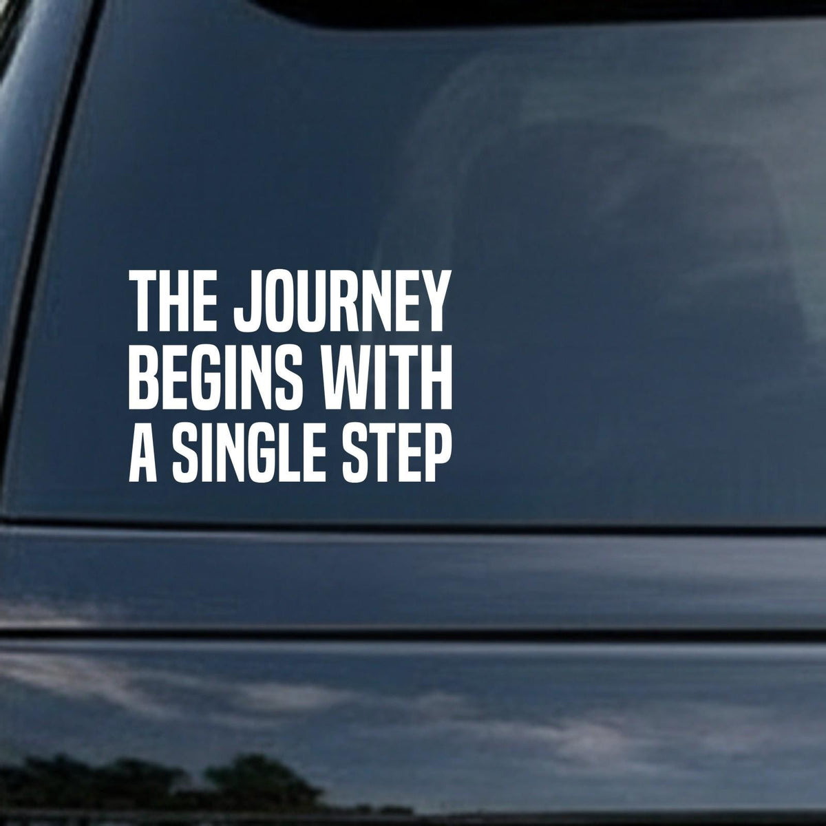 The Journey Begins With a Single Step car decal in the small 6 inch size, shown in the corner of a rear window