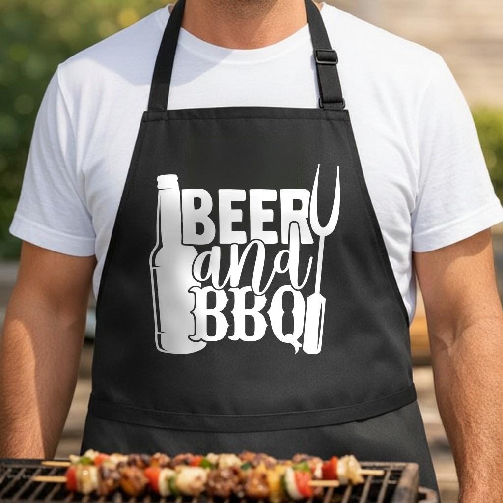 Beer and BBQ black BBQ apron, torso close-up: Black apron with white graphic of a beer bottle, barbecue fork, and the words Beer and BBQ in bold, stylized font.
