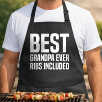 Best Grandpa Ever, Ribs Included black BBQ apron, torso close-up: Black apron with large white bold text reading Best Grandpa Ever Ribs Included in a clean, simple typography style
