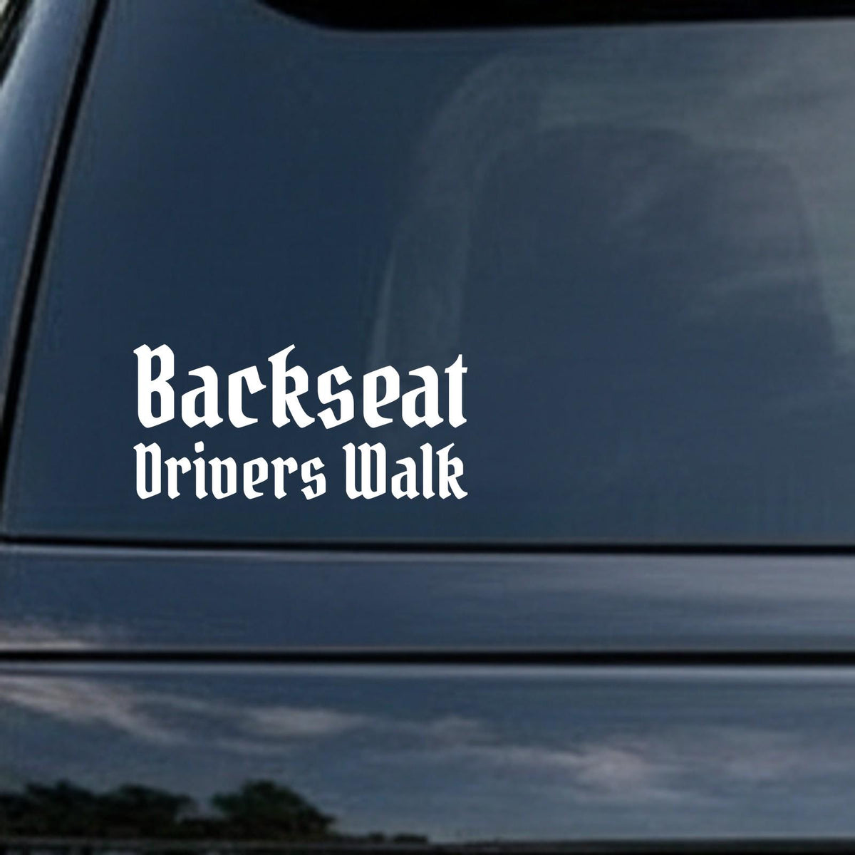 Backseat Drivers Walk (Version 2) car decal in the small 6 inch size, shown in the corner of a rear window